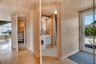 a bathroom with a washer and dryer in a house at 4 bedrooms and a beautiful view in Vinderup