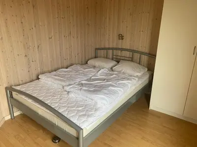 a bed with white sheets and pillows on it at 4 bedrooms and a beautiful view in Vinderup