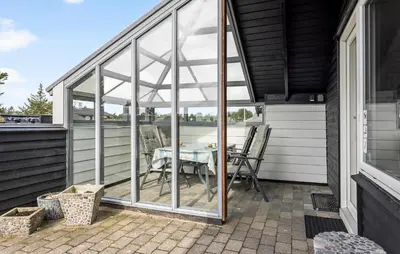 a screened in porch with a table on a patio at 2 Bedroom Amazing Home In Thisted in Thisted