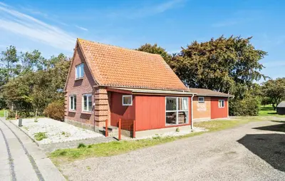 a small red house on the side of a road at Lovely Home In Bøvlingbjerg With Wifi in Bøvlingbjerg