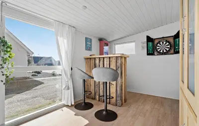a room with a chair and a clock on the wall at Lovely Home In Bøvlingbjerg With Wifi in Bøvlingbjerg