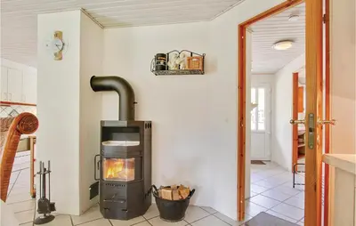 a kitchen with a stove in a room at Holiday Home Blokhus With Sauna 156 in Blokhus