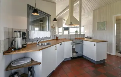 a kitchen with white cabinets and a sink at Holiday Home Vestervig With A Fireplace 164 in Vestervig