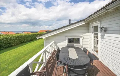 a patio with a table and chairs on a balcony at 3 Bedroom Amazing Home In Vinderup in Vinderup