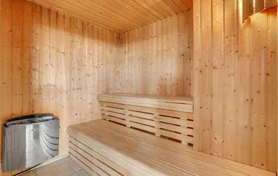 a wooden sauna with a trash can in it at 3 Bedroom Amazing Home In Vinderup in Vinderup
