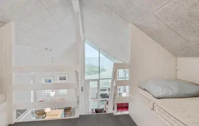 a bedroom with a bed and a large window at Nice Home In Frøstrup With Kitchen in Frøstrup