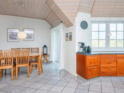 a kitchen and dining room with a table and chairs at Luxury Beach Retreat - By Traum Ferienwohnungen in Harboør