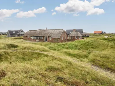 a group of houses on a hill in a field at Luxury Beach Retreat - By Traum Ferienwohnungen in Harboør