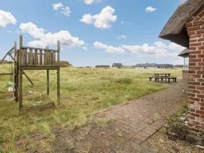 a bench and a picnic table in a field at Luxury Beach Retreat - By Traum Ferienwohnungen in Harboør