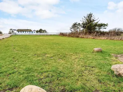 a large field of grass with a white fence at Seaside Escape with Views - By Traum Ferienwohnungen in Vestervig