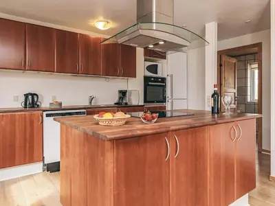 a kitchen with a wooden island with a bowl of fruit on it at Seaside Escape with Views - By Traum Ferienwohnungen in Vestervig