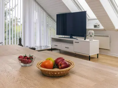 a bowl of fruit sitting on a table with a television at Seaside Escape with Views - By Traum Ferienwohnungen in Vestervig