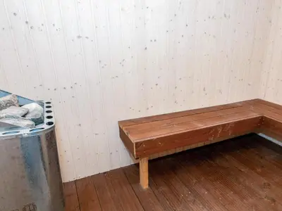 a wooden bench in a room with a trash can at Seaside Escape with Views - By Traum Ferienwohnungen in Vestervig