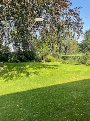 a field of green grass with a frisbee in the air at Wohnung in Salling in Buksager