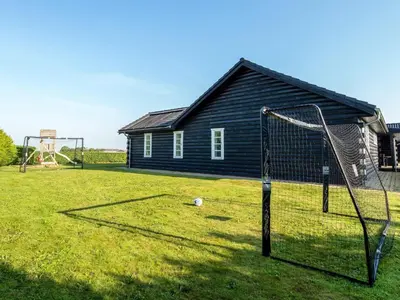 a yard with a soccer goal and a house at Luxury Lodge with Limfjord View - By Traum Ferienwohnungen in Spottrup