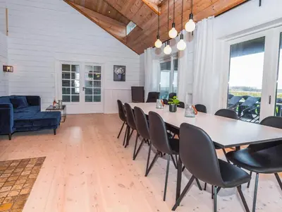 a dining room with a large table and chairs at Luxury Lodge with Limfjord View - By Traum Ferienwohnungen in Spottrup