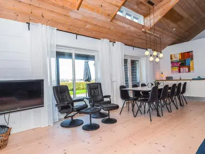 a dining room with a table and chairs at Luxury Lodge with Limfjord View - By Traum Ferienwohnungen in Spottrup