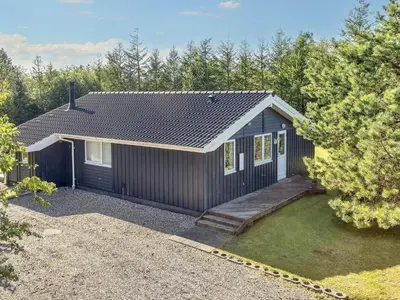 a small black house with a porch at Family Beach Retreat - By Traum Ferienwohnungen in Løgstør