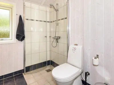a bathroom with a toilet and a shower at Family Beach Retreat - By Traum Ferienwohnungen in Løgstør