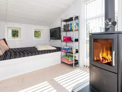 a living room with a fireplace in a room with a couch at Family Beach Retreat - By Traum Ferienwohnungen in Løgstør