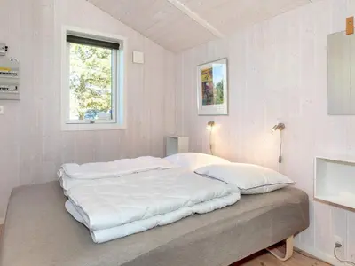 a bedroom with a large bed with white sheets at Family Beach Retreat - By Traum Ferienwohnungen in Løgstør