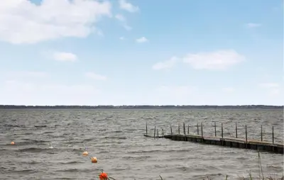 a dock on a large body of water at 3 Bedroom Beautiful Home In Thyholm in Thyholm