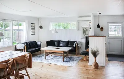 a living room with a couch and a table at 3 Bedroom Beautiful Home In Thyholm in Thyholm