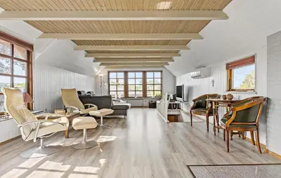 a living room with white walls and wooden ceilings at 3 Bedroom Stunning Home In Farsø in Farsø