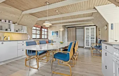 a kitchen and dining room with a table and chairs at 3 Bedroom Stunning Home In Farsø in Farsø