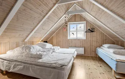 a bedroom with two beds in a attic at Lovely Home In Fur With Sauna in Fur