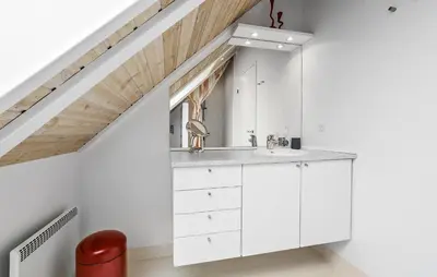 a white bathroom with a sink in a attic at Lovely Home In Fur With Sauna in Fur