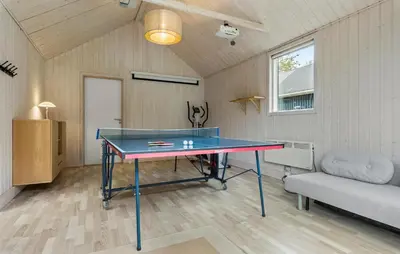 a ping pong table in a room with a couch at Beautiful Home In Farsø With Wifi in Farsø