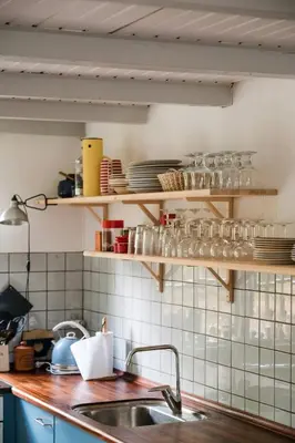 a kitchen with a sink and shelves with dishes at Summer House For The Big Family Close To The Fjord in Agger