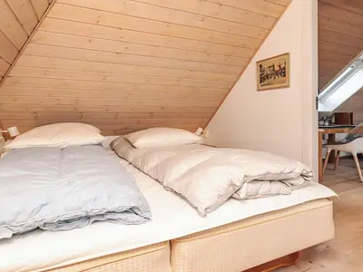two beds in a room with wooden walls at Panoramic View Fisherman's House - By Traum Ferienwohnungen in Vesløs