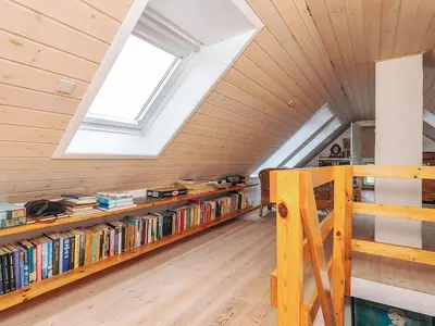 a attic room with bookshelves and a window at Panoramic View Fisherman's House - By Traum Ferienwohnungen in Vesløs