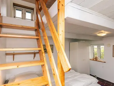a loft bed in a tiny house at Panoramic View Fisherman's House - By Traum Ferienwohnungen in Vesløs