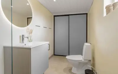 a bathroom with a toilet and a sink and a mirror at 2 Bedroom Nice Home In Thisted in Thisted
