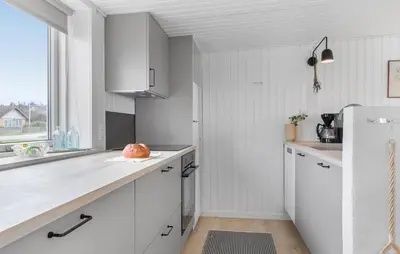 a kitchen with white cabinets and a white refrigerator at 2 Bedroom Nice Home In Thisted in Thisted