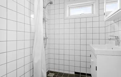 a white tiled bathroom with a sink and a shower at Pet Friendly Home In Spøttrup With Wifi in Spottrup