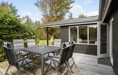 a patio with a table and chairs on a deck at Pet Friendly Home In Spøttrup With Wifi in Spottrup