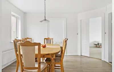 a dining room with a wooden table and chairs at 4 Bedroom Nice Home In Harboøre in Harboør
