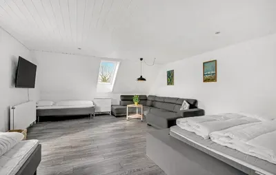 a living room with two beds and a couch at Det gamle forsamlinghus in Struer