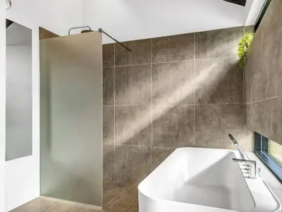 a bathroom with a white tub and a shower stall at Holiday Home Jahn - 250m to the fjord by Interhome in Højslev