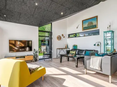 a living room with a couch and a tv at Holiday Home Jahn - 250m to the fjord by Interhome in Højslev