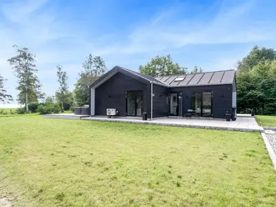 a black house with a large yard at Holiday Home Jahn - 250m to the fjord by Interhome in Højslev