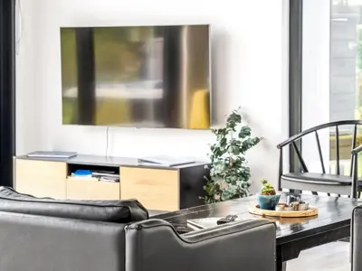a living room with a table and a tv at Holiday Home Jahn - 250m to the fjord by Interhome in Højslev
