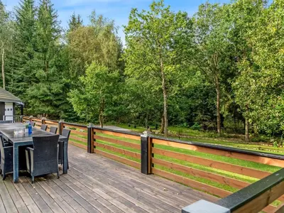 a wooden deck with a table and chairs on it at Holiday Home Vicente - 14km to the fjord by Interhome in Års