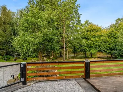 a wooden fence with a park in the background at Holiday Home Vicente - 14km to the fjord by Interhome in Års