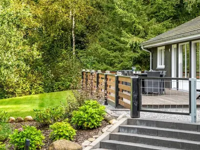a garden with stairs leading to a deck at Holiday Home Vicente - 14km to the fjord by Interhome in Års