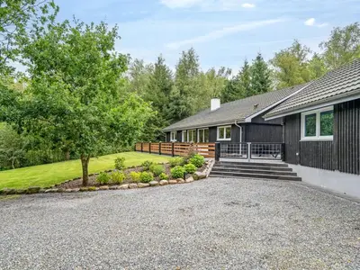 a house with a driveway in front of it at Holiday Home Vicente - 14km to the fjord by Interhome in Års